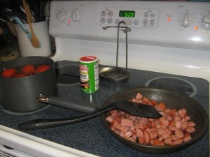 Frying the sausage and blanching tomatoes